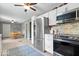 Bright kitchen with stainless steel appliances, eat-in dining area, and tile flooring at 5672 W New York St, Indianapolis, IN 46224