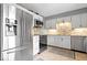 Contemporary kitchen boasts stainless steel appliances, modern lighting, and ample storage space at 5672 W New York St, Indianapolis, IN 46224