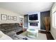 Spacious living room showcasing a contemporary fireplace with mounted TV and comfortable seating at 5672 W New York St, Indianapolis, IN 46224
