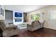 Inviting living room featuring an electric fireplace, mounted TV, and comfortable gray sofas at 5672 W New York St, Indianapolis, IN 46224
