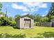 Exterior shot of the backyard storage shed, offering ample space for tools and outdoor equipment at 5672 W New York St, Indianapolis, IN 46224