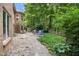 Backyard showcasing a stone patio, lush lawn and mature trees at 5720 Hickory Hollow Dr, Plainfield, IN 46168