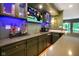 Wet bar featuring a sleek countertop, blue accent lighting, and modern appliances at 5720 Hickory Hollow Dr, Plainfield, IN 46168