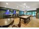 Basement with a pool table, wet bar, dining area, and a comfortable seating area at 5720 Hickory Hollow Dr, Plainfield, IN 46168