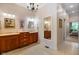 A spacious bathroom featuring double vanity sinks, large mirror, and chandelier at 5720 Hickory Hollow Dr, Plainfield, IN 46168