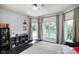 Bright bedroom featuring a ceiling fan, large windows, and built in storage at 5720 Hickory Hollow Dr, Plainfield, IN 46168