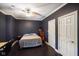 Dark bedroom with black floors, ceiling fan, large closet, and natural light at 5720 Hickory Hollow Dr, Plainfield, IN 46168