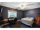 Dark bedroom with ceiling fan, desk, closet and a view of the yard at 5720 Hickory Hollow Dr, Plainfield, IN 46168