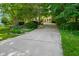 Long driveway leading to a lush, wooded lot, creating a private and serene entrance to the property at 5720 Hickory Hollow Dr, Plainfield, IN 46168