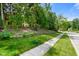 View of a charming home exterior, showcasing its landscaped front yard and a stone retaining wall at 5720 Hickory Hollow Dr, Plainfield, IN 46168