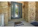 Elegant front door with glass panels, sconces, and a stone facade, creating a welcoming entryway at 5720 Hickory Hollow Dr, Plainfield, IN 46168