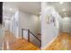 Bright hallway with hardwood floors and decorative artwork at 5720 Hickory Hollow Dr, Plainfield, IN 46168