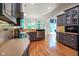 Well-lit kitchen featuring gray cabinets, tile backsplash, stainless steel appliances, and hardwood floors at 5720 Hickory Hollow Dr, Plainfield, IN 46168