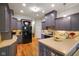Spacious kitchen with modern grey cabinetry, light countertops, and stainless steel appliances at 5720 Hickory Hollow Dr, Plainfield, IN 46168