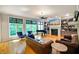 Bright living room featuring large windows, hardwood floors, a fireplace, and built-in shelving at 5720 Hickory Hollow Dr, Plainfield, IN 46168