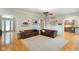 Open-concept living room with hardwood floors, arched doorways, and a view of the kitchen at 5720 Hickory Hollow Dr, Plainfield, IN 46168