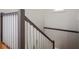 Simple staircase design showcasing white vertical supports with gray railing and wood flooring at 5720 Hickory Hollow Dr, Plainfield, IN 46168