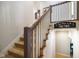 Elegant staircase featuring a white wood railing and a sign that reads 