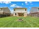 The home's back yard features a gazebo covered deck, a fire pit, and a well manicured lawn at 5841 Sable Dr, Indianapolis, IN 46221