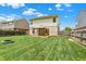 The home's back yard features a gazebo covered deck, a fire pit, and a well manicured lawn at 5841 Sable Dr, Indianapolis, IN 46221