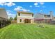 The home's back yard features a gazebo covered deck, a fire pit, and a well manicured lawn at 5841 Sable Dr, Indianapolis, IN 46221