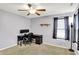 Bedroom features include a ceiling fan, a desk, a window, a lamp, and light purple colored walls at 5841 Sable Dr, Indianapolis, IN 46221