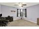 Bedroom featuring a ceiling fan, desk, and window with natural light at 5841 Sable Dr, Indianapolis, IN 46221