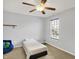 Bedroom features include a ceiling fan, a twin bed, a window, and light blue colored walls at 5841 Sable Dr, Indianapolis, IN 46221