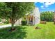 Home's exterior with a lush lawn, charming landscaping, and a welcoming entrance at 5841 Sable Dr, Indianapolis, IN 46221
