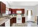The kitchen is with white appliances, stylish counters, and wood-look flooring, door to exterior at 5841 Sable Dr, Indianapolis, IN 46221