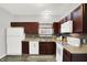 A kitchen is with white appliances, stylish counters, and wood-look flooring at 5841 Sable Dr, Indianapolis, IN 46221