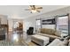 Spacious living room featuring a comfortable sofa, a ceiling fan, and hardwood floors at 5841 Sable Dr, Indianapolis, IN 46221