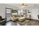 Cozy living room with natural light, a comfy sofa, and a modern ceiling fan at 5841 Sable Dr, Indianapolis, IN 46221