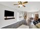 Open-concept living area with a sleek TV, a cozy sofa, and a well-lit dining area at 5841 Sable Dr, Indianapolis, IN 46221