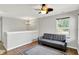 Upstairs living room with a comfortable sofa, ceiling fan, and hardwood floors at 5841 Sable Dr, Indianapolis, IN 46221