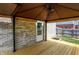 Covered patio boasts a ceiling fan, door access to the house, and an expansive outdoor area for relaxing or entertaining at 5841 Sable Dr, Indianapolis, IN 46221
