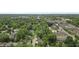 Scenic aerial view showcasing a neighborhood with lush green trees, residential homes, and nearby commercial areas at 5903 Birchwood Ave, Indianapolis, IN 46220