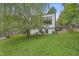 A well-maintained backyard with lush greenery and a modern home, creating a serene outdoor space at 5903 Birchwood Ave, Indianapolis, IN 46220