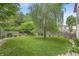 Expansive backyard featuring a large tree, a well-kept lawn, and a privacy fence at 5903 Birchwood Ave, Indianapolis, IN 46220