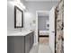 Modern bathroom featuring gray vanity, quartz countertops, and an ensuite opening into the bedroom at 5903 Birchwood Ave, Indianapolis, IN 46220