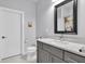 Stylish bathroom featuring vanity with a grey cabinet, marble countertops, and modern fixtures at 5903 Birchwood Ave, Indianapolis, IN 46220