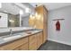 Modern bathroom featuring dual sinks, gray countertops, stylish fixtures, and walk-in shower at 5903 Birchwood Ave, Indianapolis, IN 46220