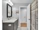 Bathroom featuring a marble vanity, modern mirror, and patterned shower curtain at 5903 Birchwood Ave, Indianapolis, IN 46220