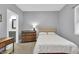 Cozy bedroom featuring neutral walls, carpet floors, and an ensuite bathroom at 5903 Birchwood Ave, Indianapolis, IN 46220
