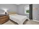 Bedroom with soft light, neutral walls, and view of the backyard from the window at 5903 Birchwood Ave, Indianapolis, IN 46220