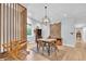 Bright dining room features modern lighting, rustic accents, and hardwood floors at 5903 Birchwood Ave, Indianapolis, IN 46220
