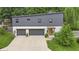 Modern two-story home featuring a gray exterior, two-car garage, and vibrant yellow front door at 5903 Birchwood Ave, Indianapolis, IN 46220