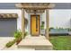 Charming front entrance featuring a bright yellow door, stylish accents, and curb appeal at 5903 Birchwood Ave, Indianapolis, IN 46220