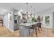 Modern kitchen with gray cabinets, stainless steel appliances, and breakfast bar seating at 5903 Birchwood Ave, Indianapolis, IN 46220