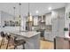 Beautiful modern kitchen with stainless appliances, pendant lighting, and gray cabinets at 5903 Birchwood Ave, Indianapolis, IN 46220